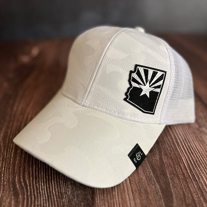 A white camouflage ponytail hat with an etched patch featuring the state cutout and flag of Arizona.