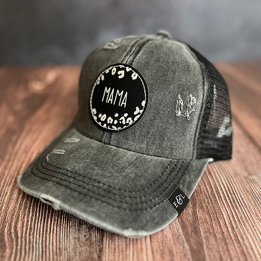 A vintage black hat with a ponytail back, featuring a vegan leather patch with the 'MAMA Leopard' design.