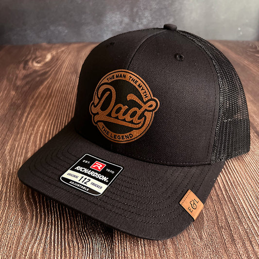 Black Richardson 112 trucker hat with a patch on the front that reads 'DAD THE MAN THE MYTH THE LEGEND'.